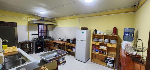 a kitchen with a white refrigerator in a room at Raven La Paz in La Paz
