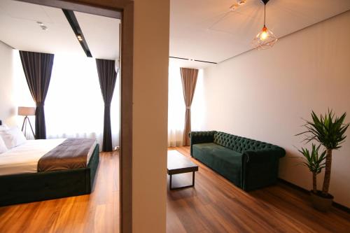 a hotel room with a bed and a couch at Casa Iacob ApartHotel in Braşov