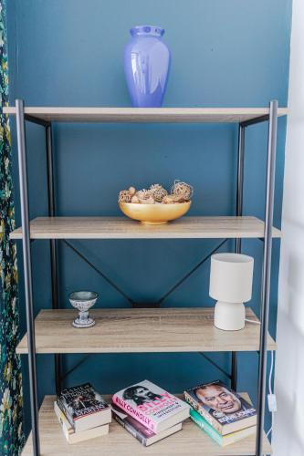 a shelf with a bowl and books on it at Carlisle House in Seaton Carew