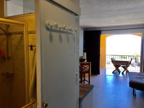 a room with a door with a view of a living room at Seafront studio in Algajola