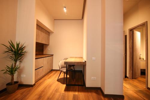 a small kitchen with a table in a room at Casa Iacob ApartHotel in Braşov