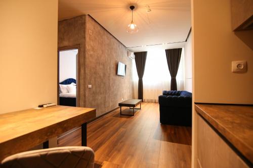 a living room with a desk and a bedroom at Casa Iacob ApartHotel in Braşov