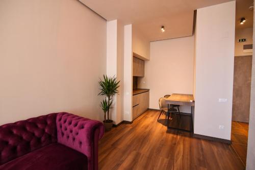 a living room with a red couch and a table at Casa Iacob ApartHotel in Braşov