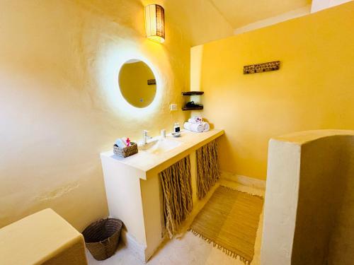 a bathroom with a sink and a mirror at Dream Luxury B&b Watamu in Watamu