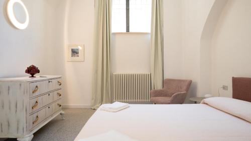 a bedroom with a bed and a dresser and a window at Chicca's Rooms in Lecce
