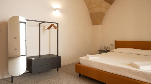 a bedroom with a bed and a dresser with a mirror at Chicca's Rooms in Lecce
