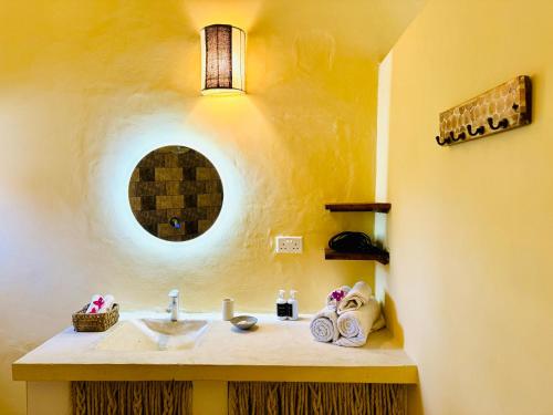 a bathroom with a sink and a mirror at Dream Luxury B&b Watamu in Watamu