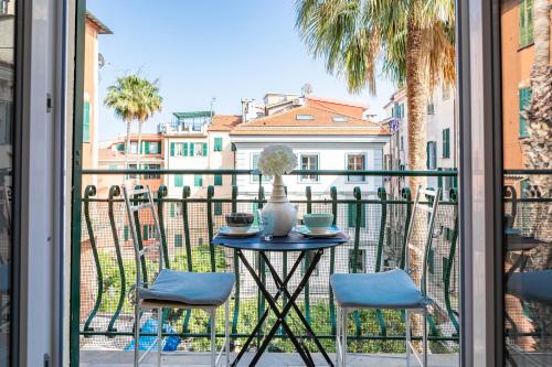 a table with a vase on it on a balcony at H11 CASA CAMILLA Centro - Sanremo in Sanremo