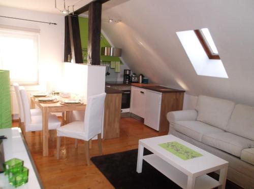 a living room with a table and a couch at Business Apartments Netzeband in Netzeband