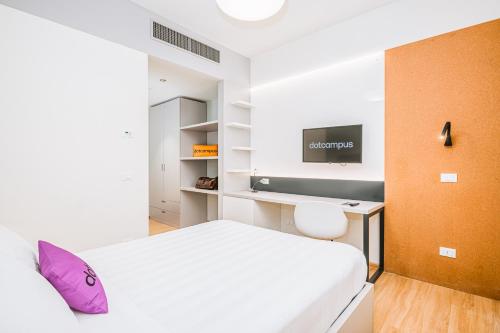 a bedroom with a bed and a desk and a tv at Dotcampus Roma City Center in Rome