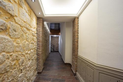 a hallway with a brick wall and a skylight at Casual Fuentes in Bilbao