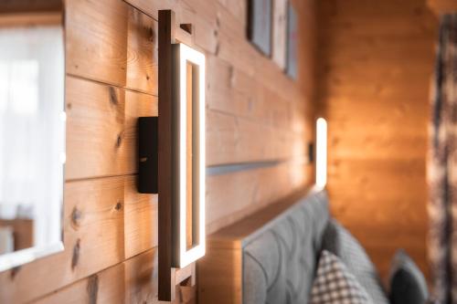 a wall with two windows and a couch in a room at Apart Schneider in Ischgl