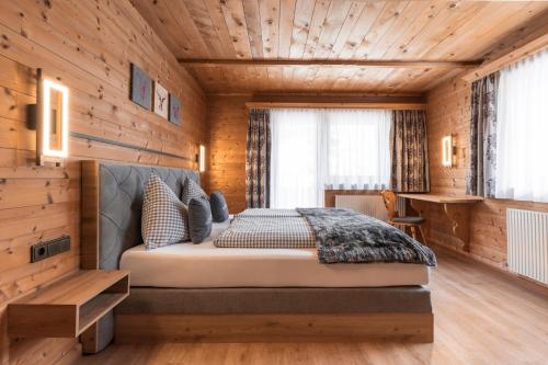 a bedroom with a bed in a wooden room at Apart Schneider in Ischgl