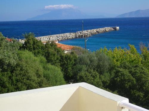 a view of a dock in the water with a mountain at Hotel Filioppi in Agios Kirykos