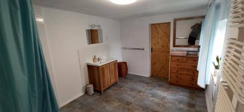 a bathroom with a sink and a wooden cabinet at Dom Przysłupowy Educare -Agroturystyka Slow Food in Świeradów-Zdrój
