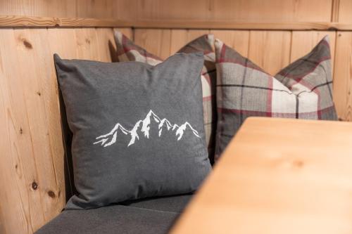 a gray pillow with a mountain printed on it at Apart Schneider in Ischgl