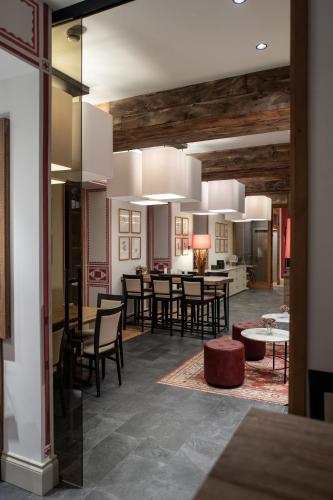 a dining room and kitchen with a dining table and chairs at Villa Carona Hotel & Spa in Carona