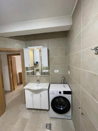 a bathroom with a washing machine and a sink at Apartment Tramontana - Konoba More in Pržno