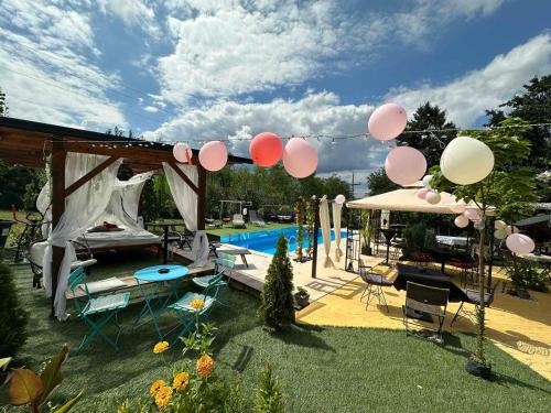 a group of balloons hanging over a swimming pool at Smestaj sa bazenom Sunny Hill in Smederevska Palanka