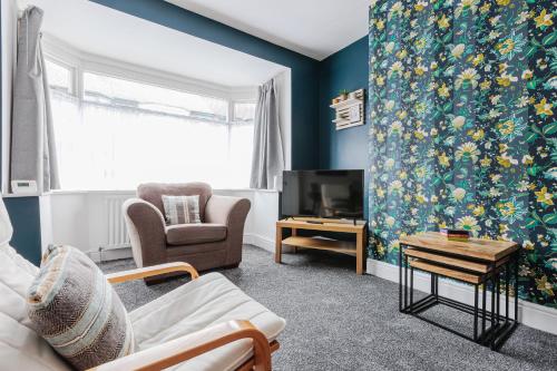 a living room with a couch a chair and a tv at Carlisle House in Seaton Carew