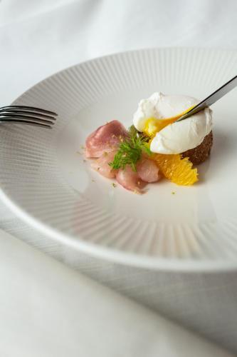 a white plate with a piece of food on it at Villa Carona Hotel & Spa in Carona