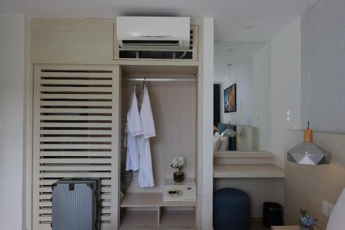 a room with a closet with white clothes at Biệt thự nghỉ dưỡng - Oceanami Villa Beach Resort in Long Hai