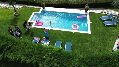 a group of people standing around a swimming pool at Retiro do Mestre in Mondim de Basto