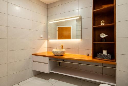 a bathroom with a sink and a mirror at Casa Antonette, Lovely house with a pool in Calheta
