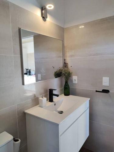 a white bathroom with a sink and a mirror at Jose Ignacio in José Ignacio