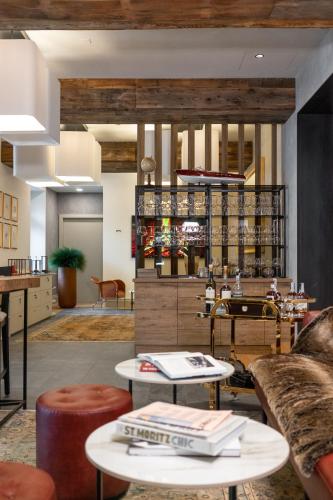 a lobby with couches and tables in a store at Villa Carona Hotel & Spa in Carona