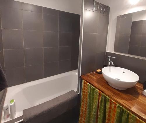 une salle de bain avec un lavabo et une baignoire dans l'établissement Nos jours heureux, à Barjac