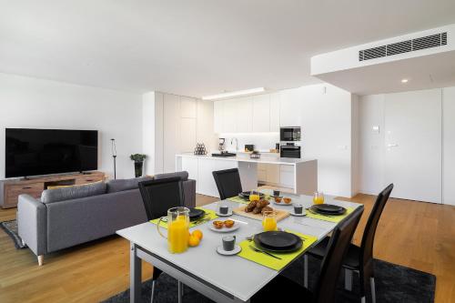 a kitchen and living room with a table with food on it at WHome History and Comfort, Luxurious Living in Benfica in Lisbon