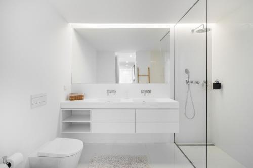 a white bathroom with a sink and a shower at WHome History and Comfort, Luxurious Living in Benfica in Lisbon