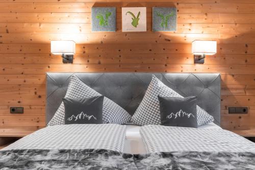 a bedroom with a bed with two pillows at Apart Schneider in Ischgl