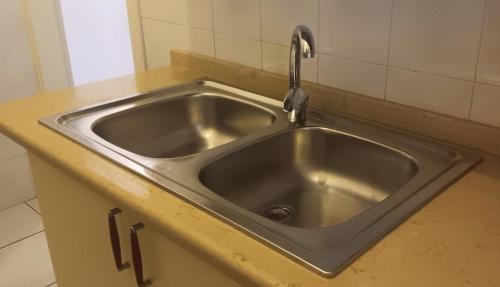 a stainless steel sink with a faucet in a kitchen at SWEET Apartment in San Giorgio Ionico