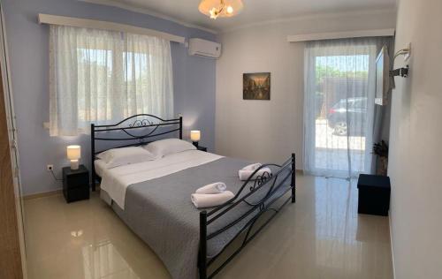 a bedroom with a bed with two pillows on it at Vagias Home in Kanali