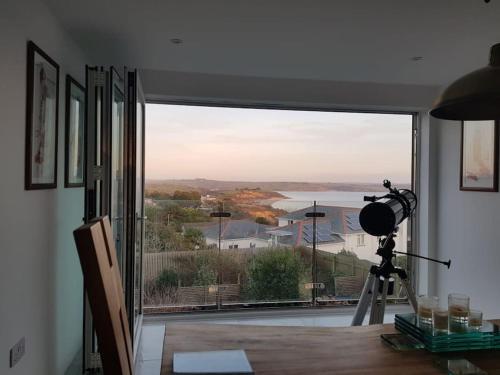 a room with a large window with a view at Harber Rise House in Carlyon Bay