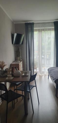 a living room with a table and chairs and a couch at Noclegi Szczawnica in Szczawnica