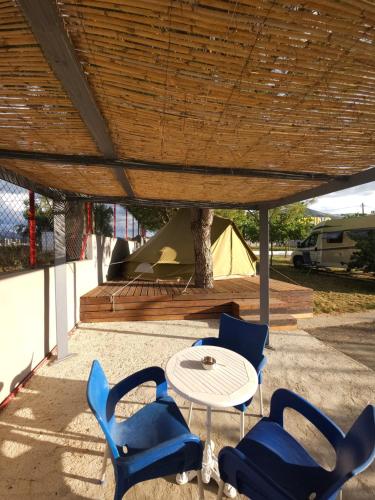 a group of blue chairs and a table and a tent at Ioannina Camping- Glamping in Neo Mpizani