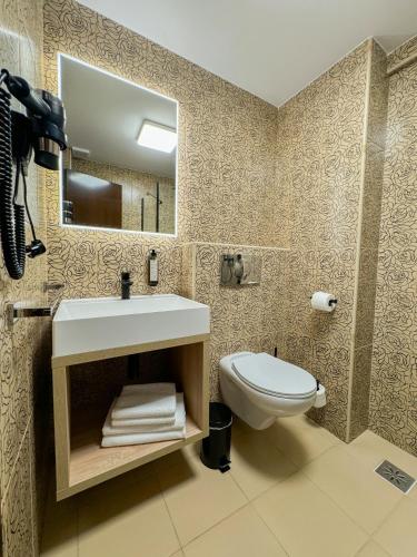 a bathroom with a sink and a toilet at Hotel FAN Sebes in Sebeş