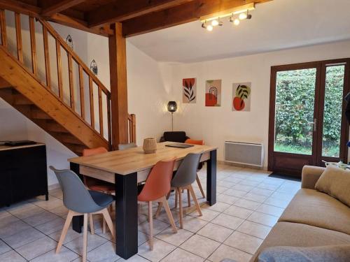 un salon avec une table et des chaises en bois dans l'établissement Maison 6 pers Evasion Landaise proche plage et à côté du lac, à Vielle-Saint-Girons