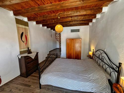 a bedroom with a bed with a wooden ceiling at Velanidia Homestay in Velanídhia