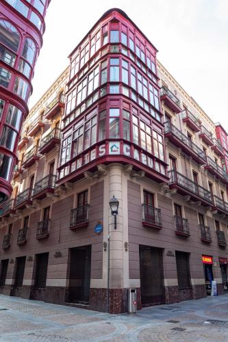 a tall building with a red and white at Casual Fuentes in Bilbao