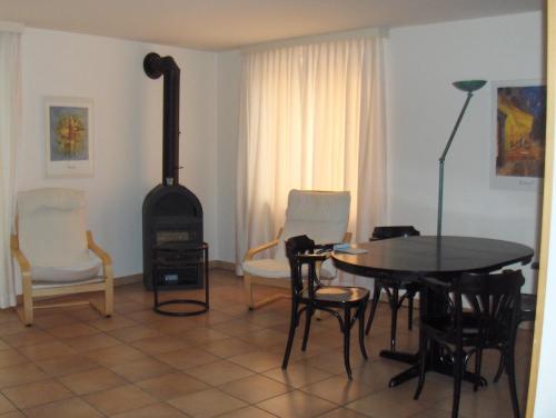 a living room with a table and a wood stove at Appartamenti della Ruga in Ascona