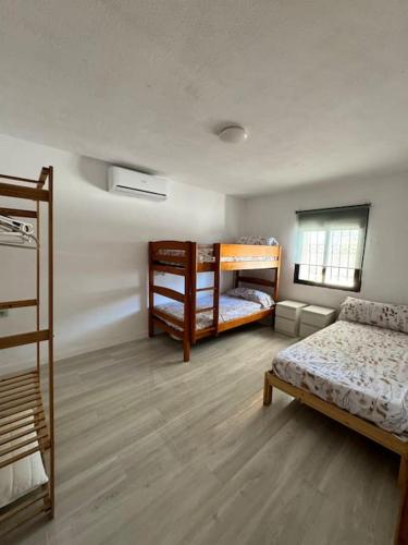 a room with two bunk beds and a couch at Villa con piscina privada in Alicante