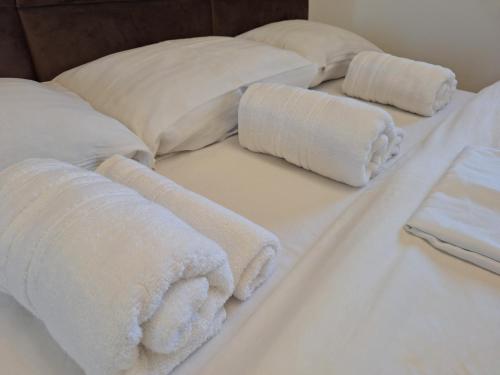 a bed with white towels and pillows on it at RIVIJERA CITY in Belgrade