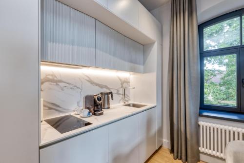 a kitchen with a sink and a window at Apartments Vitenberg in Cēsis