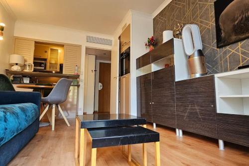 a living room with a couch and a table at Paris La Defense - Modern Apartment with Jacuzzi in Courbevoie