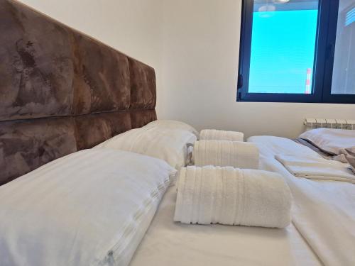 a room with three beds with white sheets at RIVIJERA CITY in Belgrade
