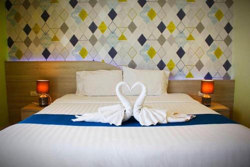 two swans making a heart shape on a bed at The Icon Place 1 @ Central Pattaya in Pattaya